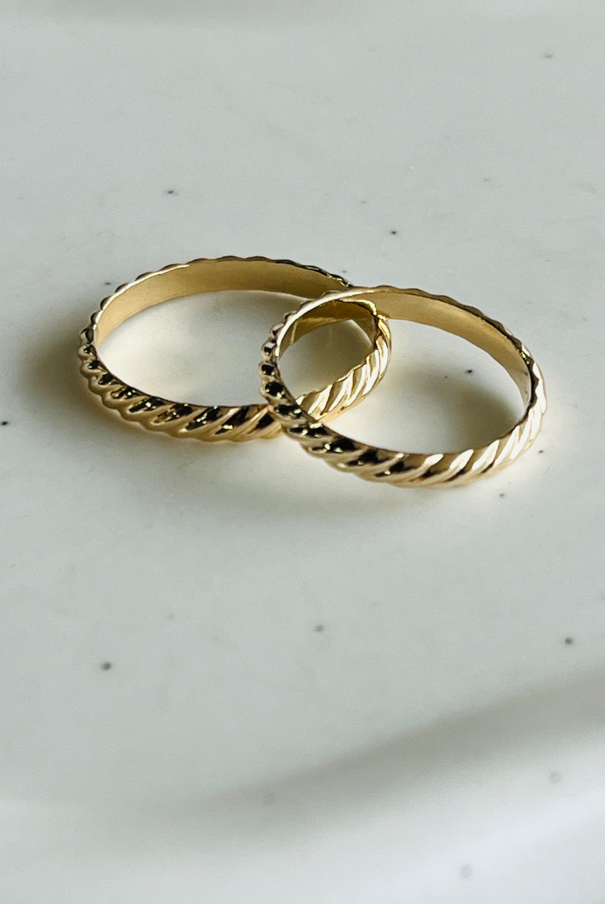 a couple of rings sitting on top of a white plate