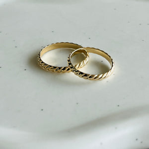 a couple of rings sitting on top of a white plate