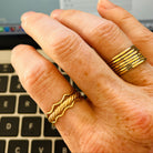 Hand with gold rings on a computer keyboard