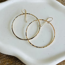 Load image into Gallery viewer, a pair of gold hoop earrings on a white plate

