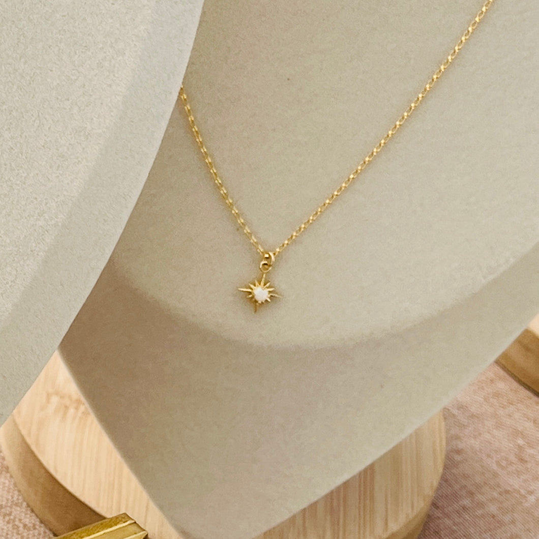 a gold necklace with a star on it