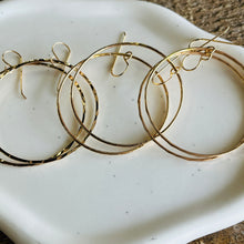 Load image into Gallery viewer, three pairs of gold hoop earrings on a white plate
